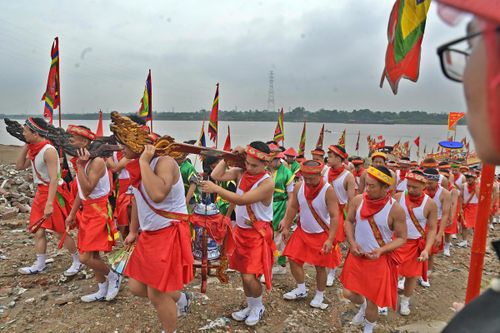 Đội phù giá mặc “váy cuốn” cùng đoàn rước chóe nước về đình.