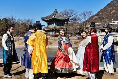 Khách du lịch Mỹ mặc trang phục truyền thống Hanbok của Hàn Quốc, chụp ảnh lưu niệm khi tham quan Cung điện Gyeongbokgung ở Seoul ngày 17/2. Ảnh: EPA-Yonhap