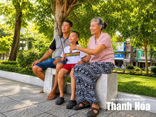 Vợ chồng ông Hồ Hữu Lực cùng các cháu nghỉ ngơi, trò chuyện sau mỗi buổi dạo công viên.