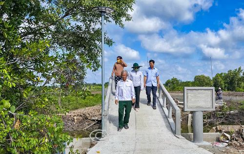 Bà con địa phương phấn khởi khi công trình cầu ở ấp Hòa 2, xã Long Ðiền, cơ bản hoàn thành, từ nguồn kinh phí do Liên hiệp Các tổ chức hữu nghị tỉnh vận động hỗ trợ.