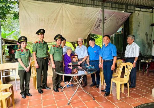 Đoàn đến trao quà và ảnh con trai của mẹ Lê Thị Chí (98 tuổi) được phục dựng lại.