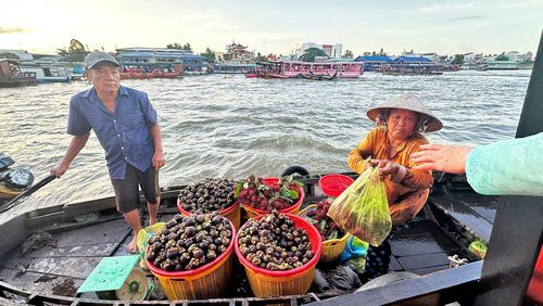 Điểm độc đáo của chợ nổi là mỗi ghe đều dựng một cây sào treo những mặt hàng đang bán như dứa, xoài, bí đỏ, khoai, dưa hấu hay các loại trái cây theo mùa. Ảnh: Người dân buôn bán trên sông. 