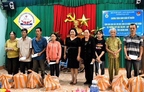 Bà Nguyễn Thị Tám (thứ 4 từ phải sang) trao quà hỗ trợ hộ khó khăn tại huyện Bắc Trà My (cũ) trong chuyến về nguồn năm 2019. Ảnh: NGUYỄN SỐ