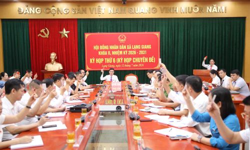 Các đại biểu HĐND xã Lạng Giang biểu quyết thông qua nghị quyết.
