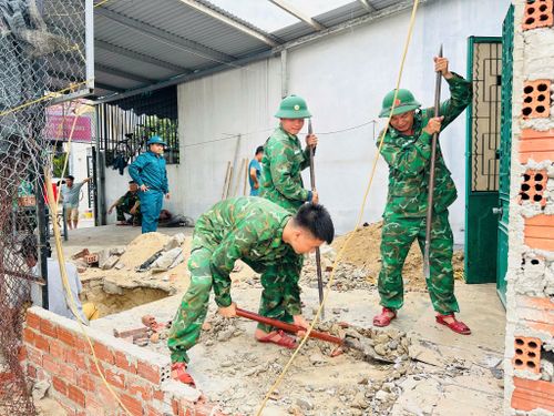 Cán bộ, chiến sĩ Đồn Biên phòng Non Nước cùng lực lượng dân quân Ban Chỉ huy Quân sự phường Ngũ Hành Sơn hỗ trợ xây dựng nhà cho bà Huỳnh Thị Tiệp (phường Ngũ Hành Sơn). Ảnh: P.A