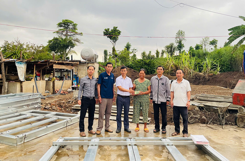 Đại diện cấp ủy, chính quyền xã Ea M’droh trao kinh phí xây nhà hỗ trợ gia đình bà Nông Thị Nga.
