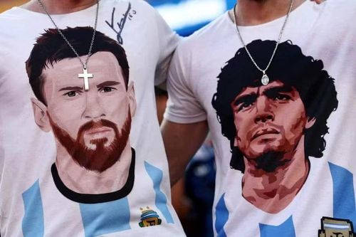 Lionel Messi và cố huyền thoại Diego Maradona xuất hiện trên áo của 2 CĐV Argentina, tượng trưng cho 2 thế hệ vĩ đại của bóng đá nước này. Ảnh: Reuters.