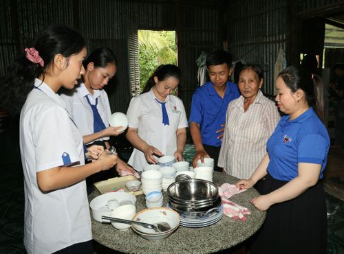 Các em học sinh, các bạn đoàn viên thanh niên chuẩn bị mâm cơm cúng đồng chí Châu Văn Liêm nhân kỉ niệm 79 năm Ngày Thương binh - Liệt sĩ