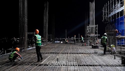 Không khí lao động khẩn trương, tập trung dưới ánh đèn cao áp.