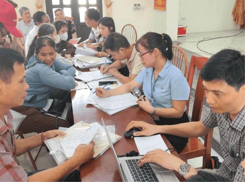 Tổ công tác xã Đan Phượng hướng dẫn người dân kê khai thông tin đất đai. Ảnh: Nga Nguyễn