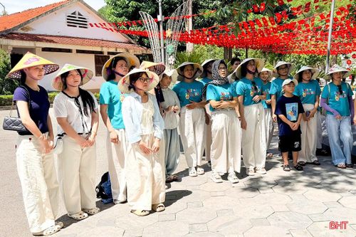 Du khách chăm chú trước bức thư chị Võ Thị Tần gửi mẹ tại Ngã ba Đồng Lộc.