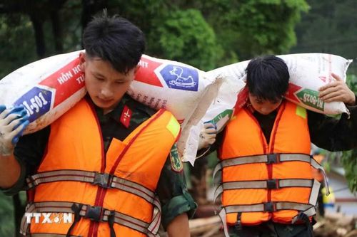 Các lực lượng cứu hộ của tỉnh Lai Châu giúp người dân Mường Than di dời tài sản đến nơi an toàn. (Ảnh: Nguyễn Oanh/TTXVN)