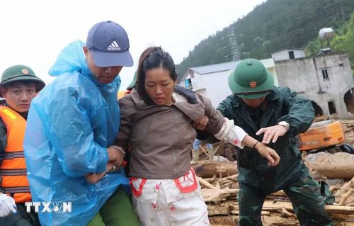 Các lực lượng cứu hộ giúp người dân di chuyển đến nơi an toàn. (Ảnh: Nguyễn Oanh/TTXVN)