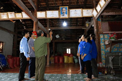 Ông Nông Văn Cắm giới thiệu cho thế hệ trẻ xã Cát Tiên 2 về niềm tự hào khi treo ảnh Bác Hồ trong ngôi nhà của gia đình ngay từ những ngày đầu dựng nhà, cách đây hàng chục năm