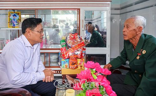  Đồng chí Bùi Tấn Bảy trò chuyện cùng ông Trần Văn Thiên, thương binh 4/4, tại ấp Cây Sộp.