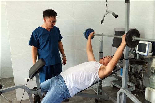 Theo dõi quá trình luyện tập của thương, bệnh binh. Ảnh: Đoàn Mạnh Dương/TTXVN
