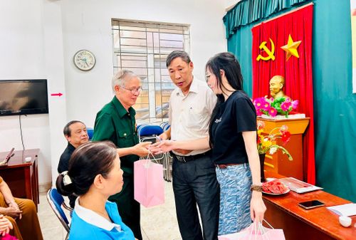 Tổ trưởng Tổ dân phố số 14 Phạm Như Hiền cùng chị Phạm Thị Thu Hương trao quà tới người có công và đại diện gia đình chính sách. Ảnh: Trần Oanh.