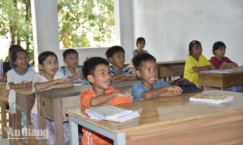 Các em học sinh chăm chú đọc tiếng Khmer trong lớp học tại chùa.
