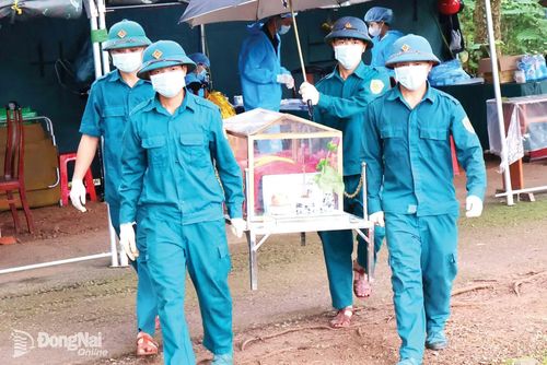 Lực lượng di chuyển hài cốt liệt sĩ đến khu vực lấy mẫu phục vụ xét nghiệm ADN.
