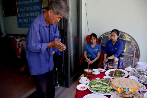 Con trai mẹ Tính khấn vái hương hồn cha và chị gái là liệt sĩ tại bữa cơm tri ân của Đoàn phường. Ảnh: HÀN NGUYÊN