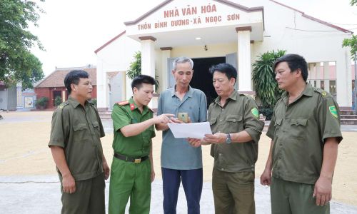 Thành viên Tổ bảo vệ an ninh, trật tự thôn Bình Dương phối hợp với cán bộ Công an xã Hoàng Vân hướng dẫn người dân nộp hồ sơ trực tuyến.