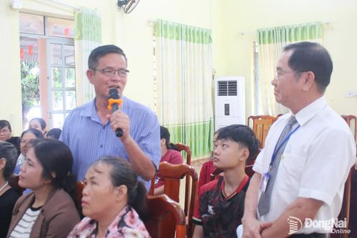 Người dân xã Nha Bích trao đổi với luật gia Dương Văn Tín, Phó Chủ tịch Hội Luật gia thành phố Đồng Nai (bìa phải) về trách nhiệm bồi thường khi vật nuôi gây hại.