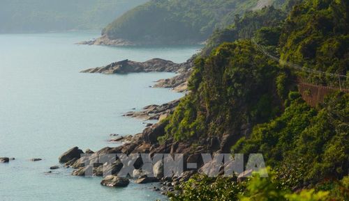 Những khối đá nhấp nhô, sắc cạnh vươn ra biển, hòa cùng làn nước trong veo xanh ngọc bích của vịnh Lăng Cô. Ảnh: Văn Dũng-TTXVN