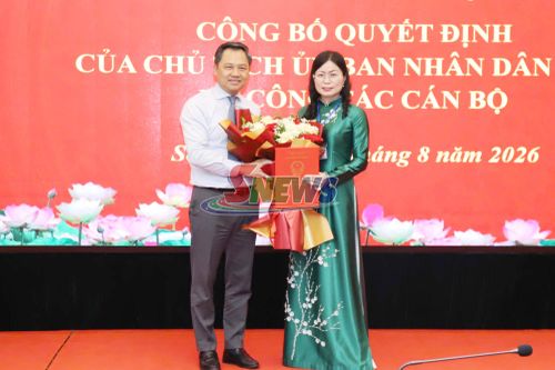 Đồng chí Nguyễn Đình Việt trao quyết định và tặng hoa chúc mừng đồng chí Hà Thị Ngọc Yến.
