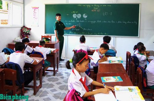 Thầy giáo quân hàm xanh Bộ đội Biên phòng tỉnh Cà Mau dạy học cho trẻ em ở khu vực biên giới. Ảnh: Hoàng Tá