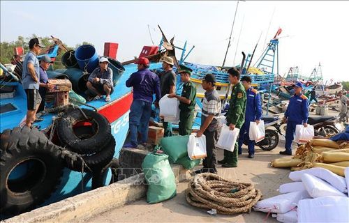 Bộ đội Biên phòng tỉnh Đồng Tháp tặng quà và tuyên truyền về phòng, chống khai thác IUU cho ngư dân ở Cảng cá Vàm Láng, xã Gia Thuận, tỉnh Đồng Tháp. Ảnh tư liệu: Hữu Chí/TTXVN