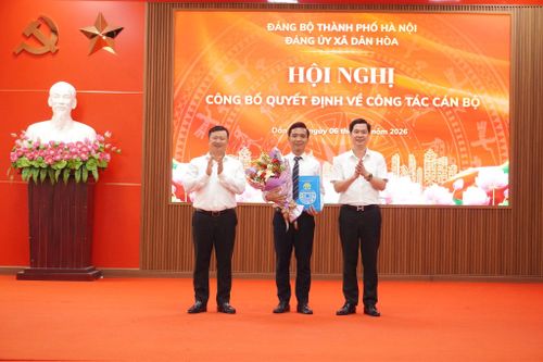 Lãnh đạo xã Dân Hòa trao quyết định, tặng hoa chúc mừng đồng chí Nguyễn Thành Luân - Tân Chánh Văn phòng HĐND - UBND xã. Ảnh: Lê Dung.