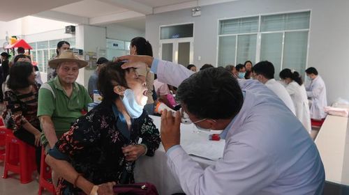Các y, bác sĩ đang thực hiện thăm khám sức khoẻ cho người dân. 