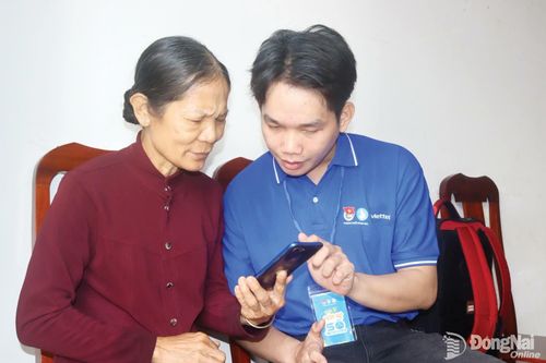 Chiến sĩ đội hình tình nguyện Mùa hè số hướng dẫn người dân xã Thanh Sơn sử dụng ứng dụng VNeID để tra cứu thông tin, thực hiện thủ tục hành chính.