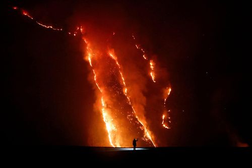  Một người quan sát đám cháy trên sườn đồi tại Vườn quốc gia Bromo Tengger Semeru, tỉnh Đông Java, Indonesia, ngày 9/8. Ảnh: Reuters. 