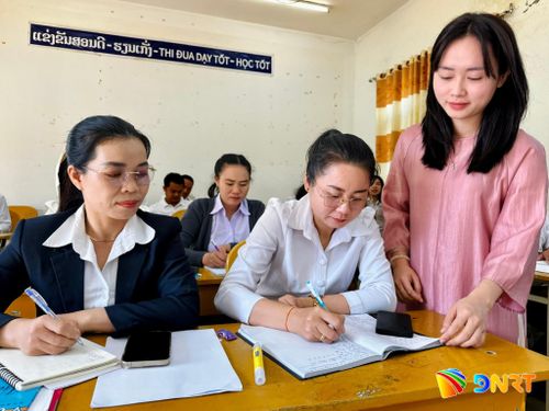 Cô giáo Doãn Thị Bảo An (bên phải) hướng dẫn học viên viết tiếng Việt tại Trung tâm Tiếng Việt tỉnh Savannakhet (ảnh chụp vào tháng 3/2026). Ảnh: ALĂNG NGƯỚC