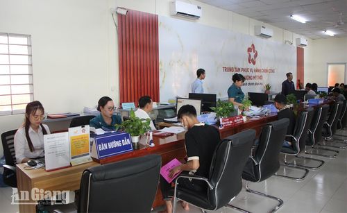 Công chức Trung tâm Phục vụ hành chính công phường Mỹ Thới hỗ trợ người dân thực hiện thủ tục hành chính. Ảnh: HẠNH CHÂU