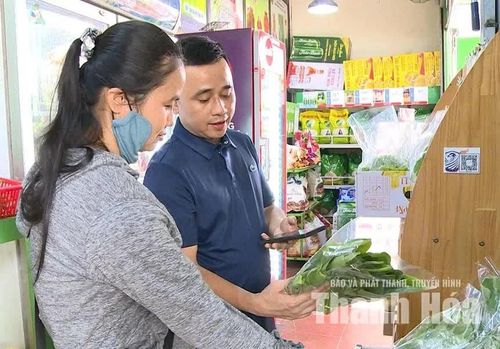 Ông Đặng Thế Tuấn Anh, quản lý Cửa hàng thực phẩm sạch Minh Anh tư vấn sản phẩm cho khách hàng. Ảnh: Hồng Tư