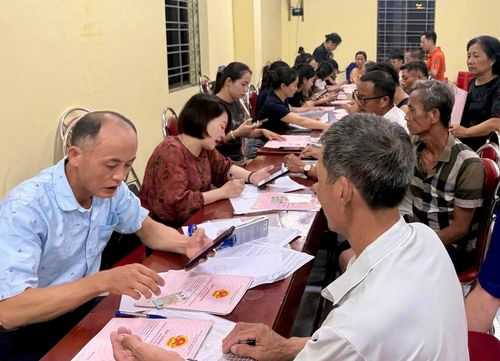 Cán bộ xã Ứng Thiên thực hiện cập nhật thông tin giấy chứng nhận quyền sử dụng đất của người dân. Ảnh: Đỗ Hà