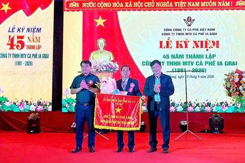 Bí thư Đảng ủy, Chủ tịch HĐND xã Ia Hrung Tống Thới Mốc (bìa trái) cùng Phó Giám đốc Báo và phát thanh, truyền hình Gia Lai Huỳnh Kiên trao cờ thi đua của UBND tỉnh Gia Lai cho tập thể Công ty TNHH MTV cà phê Ia Grai. Ảnh: N.D