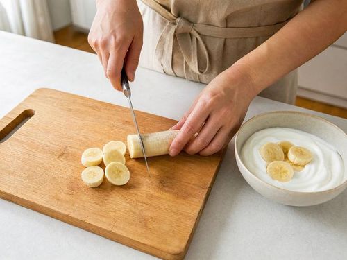 Kết hợp chuối cùng thực phẩm giàu protein như sữa chua có thể tạo thành bữa phụ cân đối. Ảnh AI.