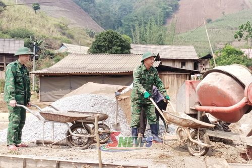 Cán bộ, chiến sĩ Đồn Biên phòng Phiêng Pằn và nhân dân đổ bê tông đường vào bản Ta Lúc.