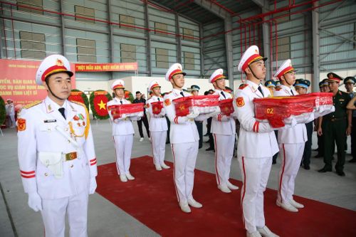 100 thùng mẫu sinh phẩm hài cốt liệt sĩ được phủ Quốc kỳ trang nghiêm.