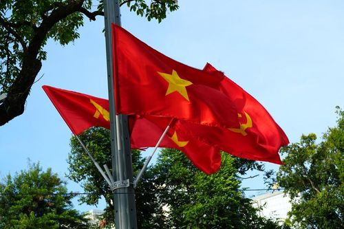 Cờ đỏ sao vàng tung bay rực rỡ trên phố Đinh Tiên Hoàng và khu vực Hồ Gươm, tạo nên bầu không khí trang nghiêm, phấn khởi.