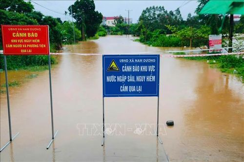 Lực lượng chức năng đặt biển cảnh báo tại các khu vực bị ngập, chia cắt do nước lũ. Ảnh: Đồng Thúy/TTXVN