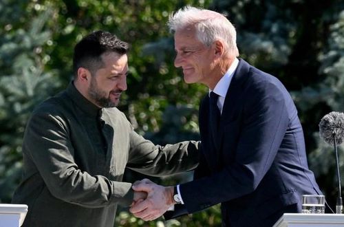 Tổng thống Volodymyr Zelensky (trái) và Thủ tướng Na Uy Jonas Gahr Store bắt tay nhau trong buổi lễ kỷ niệm Ngày Quốc kỳ Ukraine tại Kyiv hôm 23/8/2026. (Ảnh: Sergei SUPINSKY /AFP qua Kyivpost)