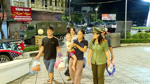 Lực lượng chức năng đưa người già, trẻ nhỏ về nhà khách.
