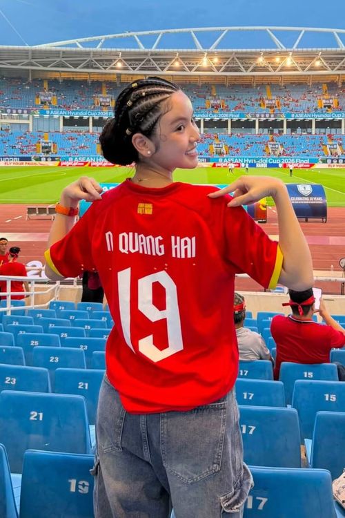 Chu Thanh Huyền xuất hiện trên khán đài từ sớm, mặc áo in tên Nguyễn Quang Hải cùng số 19. Ở trận lượt đi ngày 22/8, Quang Hải ghi bàn nâng tỷ số lên 2-0, giúp Việt Nam tạo lợi thế lớn trước trận lượt về. Vợ tiền vệ sinh năm 1997 kỳ vọng đội tuyển hoàn thành mục tiêu bảo vệ chức vô địch trên sân nhà.