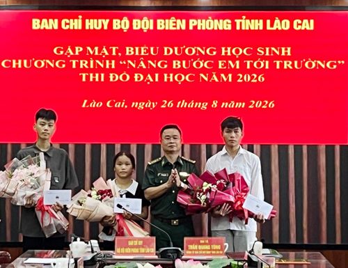 Đại tá Trần Quang Tùng, Chính ủy BĐBP tỉnh Lào Cai, tặng hoa chúc mừng các em đỗ đại học