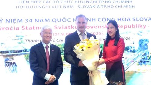 Chủ tịch Liên hiệp các tổ chức hữu nghị TPHCM Hà Thanh trao hoa chúc mừng Đại biện lâm thời Cộng hòa Slovakia tại Việt Nam Marian Veres. Ảnh: THỤY VŨ