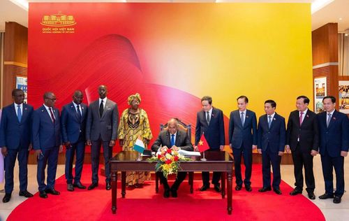 Chủ tịch Quốc hội Bờ Biển Ngà Patrick Achi ký sổ lưu niệm. (Nguồn: Quochoi.vn)